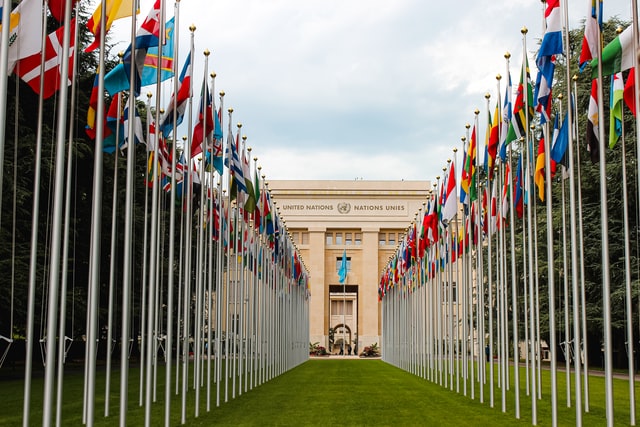 A United Nation building with flags near the entrance